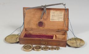 A BOX SET OF BRASS BALANCE SCALES AND WEIGHTS.