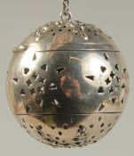 A SILVER GLOBULAR TEA INFUSER on a chain. 1.75ins diameter.