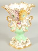 A GOOD LARGE FLOWER ENCRUSTED URN with gilt decoration, pierced handles and painted with flowers.