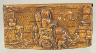 A DUTCH WOODEN SNUFF BOX the lid with a cottage interior scene. 4ins diameter.