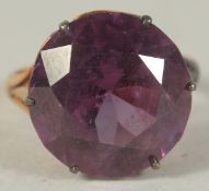 A LARGE SINGLE STONE SYNTHETIC ALEXANDRITE set in 14ct gold.