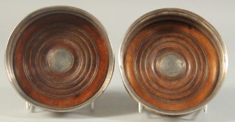 A PAIR OF OLD SHEFFIELD PLATE WINE COASTERS with turned wood bases.