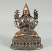 A CHINESE BRONZE FIGURE set with stones.