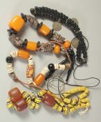 FOUR ISLAMIC NECKLACES.