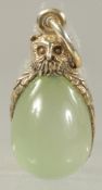 A SILVER AND JADE OWL PENDANT.
