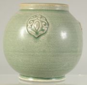 A CHINESE GREEN GLAZE POTTERY VASE with three moulded bosses. 11cm high.