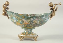 AN OVAL PORCELAIN BOWL with gilt metal cupids. 11ins wide.