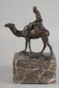 A GOOD AUSTRIAN BRONZE OF AN ARAB RIDING A CAMEL. 5.5ins high on a marble base.