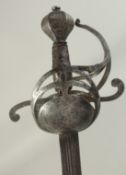 A ENGLISH SWEPT HILT BACKSWORD RAPIER, single edged multi fullered 36in blade. Sheet metal hilt with