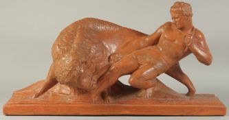 PIERRE POLBERT. CIRCA. 1930. A GOOD LARGE ART DECO TERRA COTTA GROUP OF A CLASSICAL YOUNG MAN
