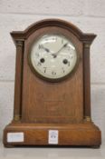 An oak cased mantle clock.