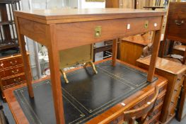 A teak rectangular fold-over dining table.