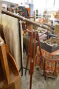Brass telescope on tripod stand.