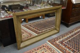 A large modern wall mirror with moulded frame.