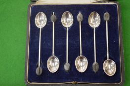 A cased set of six silver coffee bean spoons.