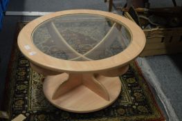 A modern glass top circular coffee table.