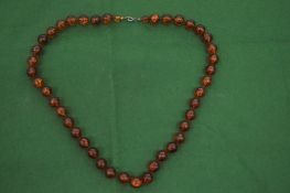 An amber graduated bead necklace.