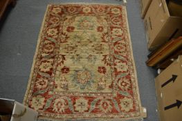 A Persian design rug cream ground with red and blue floral decoration, 148cm x 108cm.