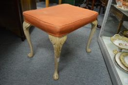 A carved and painted stool.