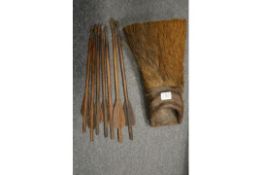 An animal skin quiver containing wooden crossbow bolts.