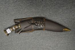 A Kukri with scabbard and extra knives.
