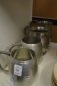 Four pewter tankards.