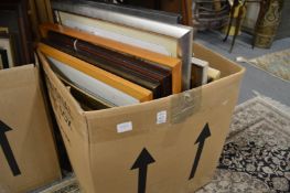 A box of assorted paintings and prints.