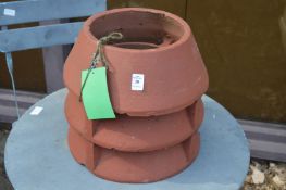 A small terracotta chimney pot.