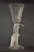 An18th century English wine glass with inverted bell bowl and air twist stem, with knop.