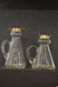 Two silver mounted glass whiskey tots and a similar item.