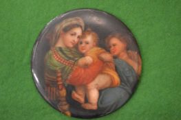 A small circular porcelain plaque painted with mother and children.