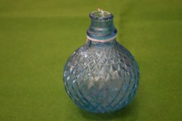 A small moulded blue glass bottle.