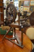 An early spinning wheel with accessories.