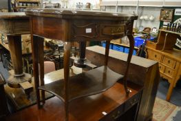 A mahogany fold over card table of serpentine outline on cabriole legs united by an under tier.
