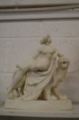 A good Parian group of a classical female nude seated on the back of a lion.
