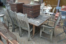 An Alexander Rose rectangular weathered teak garden table with seven chairs, two with arms.