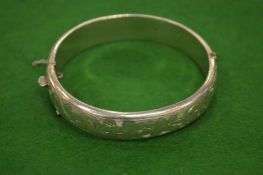 A silver bangle.