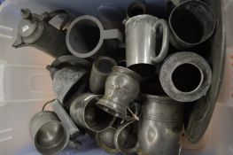 A quantity of pewter tankards etc.