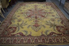 A large Persian style machine made carpet, cream ground with floral decoration, 410cm x 320cm.