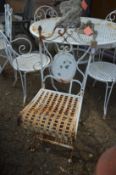 A pair of white painted metal folding garden chairs.