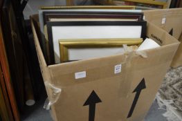 A box of assorted paintings and prints.