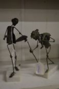 A pair of unusual metal figures.