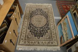 A Persian part silk rug, cream ground with stylised decoration 155cm x 93cm.