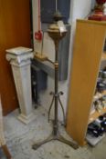 An ornate brass floor standing oil lamp.