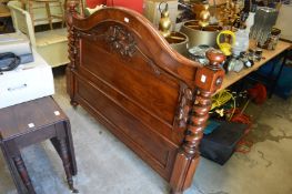 An ornate Victorian mahogany headboard.
