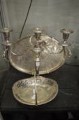 A plated swing handle basket, three light candelabra and twin handled tray.