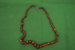 A good small amber and bead necklace of graduated beads.