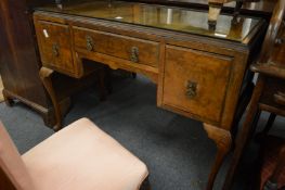 A walnut three drawer side table.