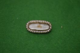 A George III gold and seed pearl mounted brooch.