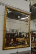 A gilt framed mirror.
